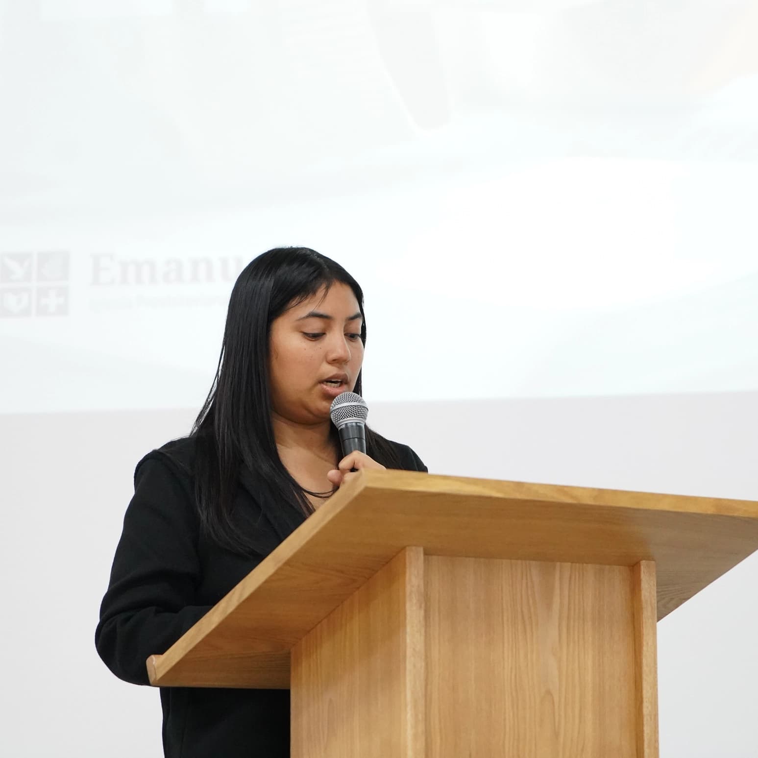 An AM staff member speaking at a lectern