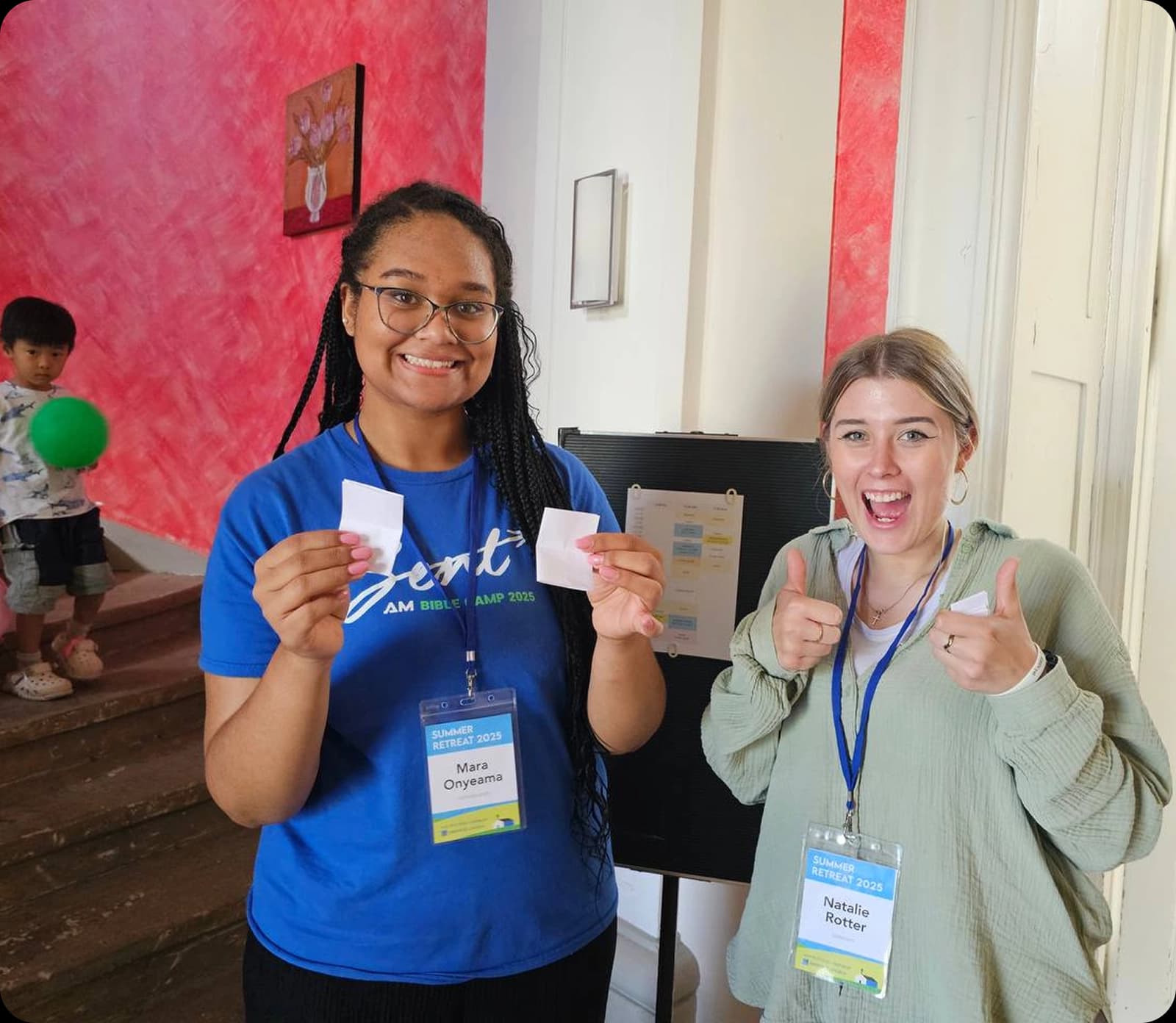 Two volunteers on the welcome desk at an AM event